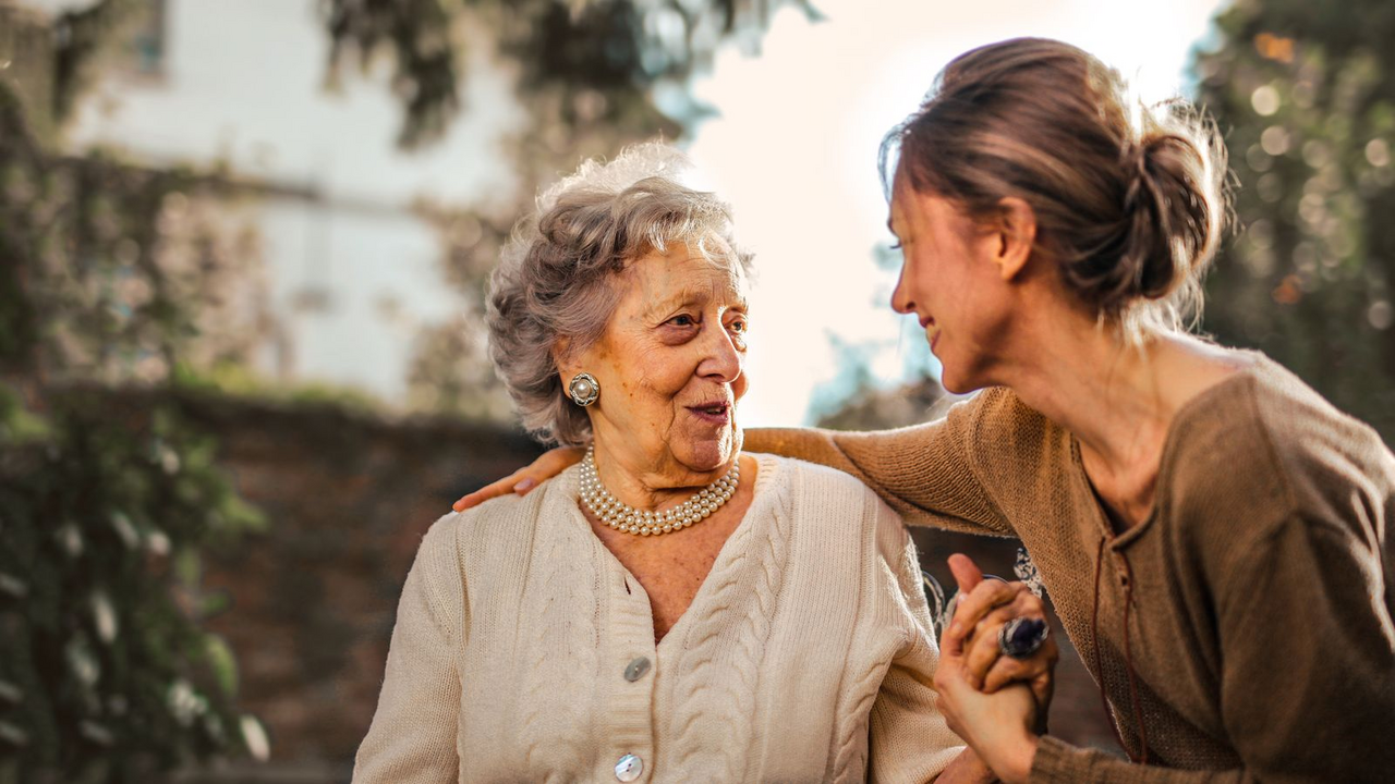 Senior Medicare client with a trusted advisor outdoors